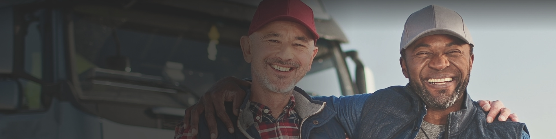 Two men smiling and hugging